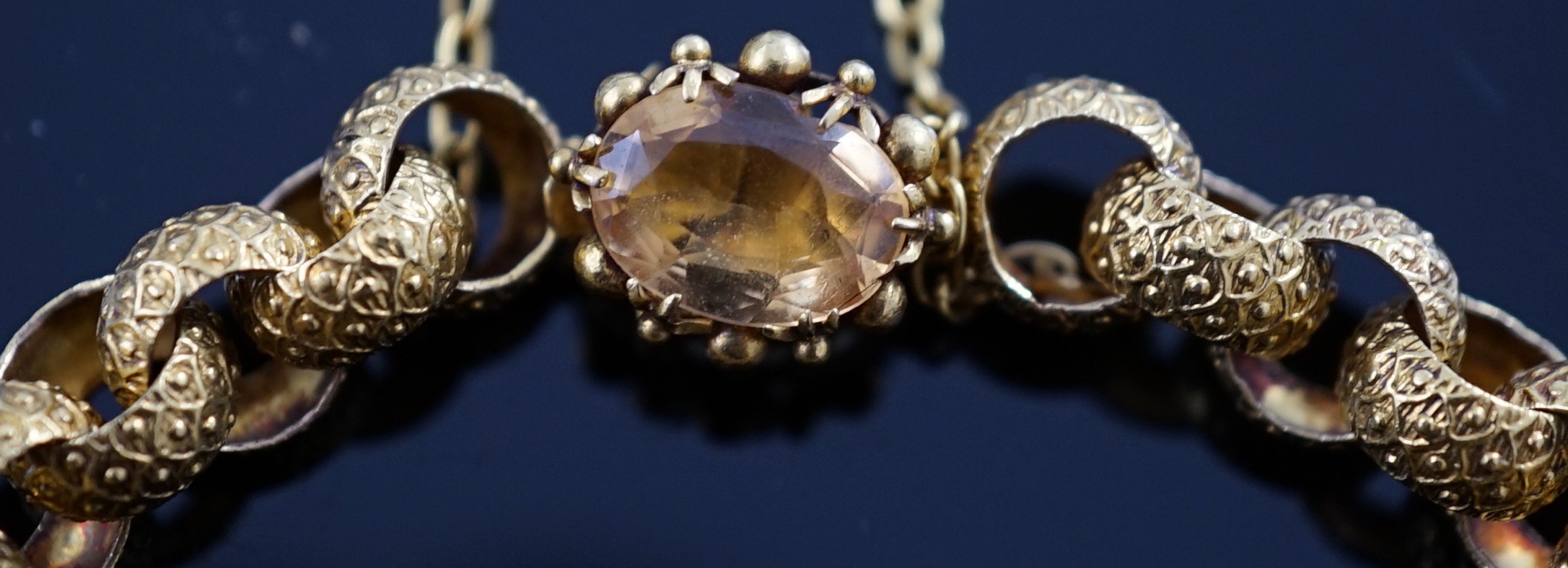 A 19th century cannetille work gold and four stone oval cut citrine set circular link bracelet